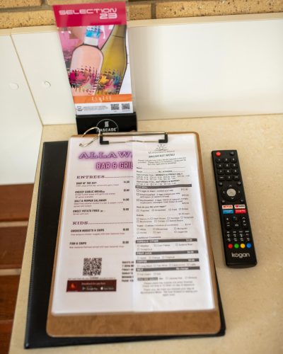 Allawah Bar & Grill Menu on top of the table beside a remote control