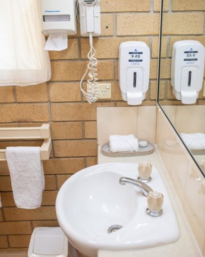 White bathroom essentials and white lavatory in the King Premium Room at Mundubbera Motel