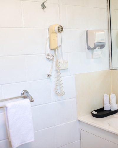 White bathroom essentials and white lavatory in Queen Single Room at Mundubbera Motel