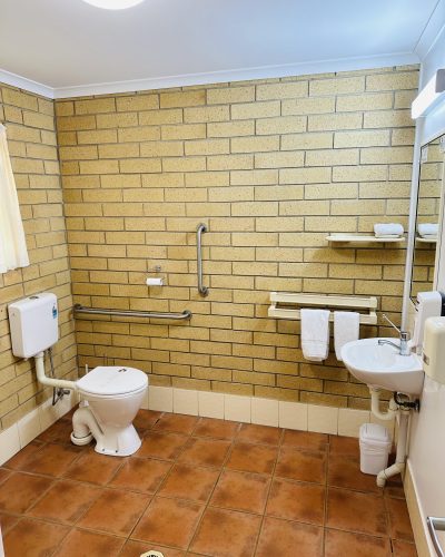 White toilet and lavatory of Disabled Access safety bathroom at Mundubbera Motel